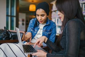 Two women checking Wonsta WordPress Hosting in Laptop.