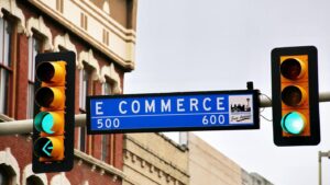 Street sign showing “E Commerce” by traffic light